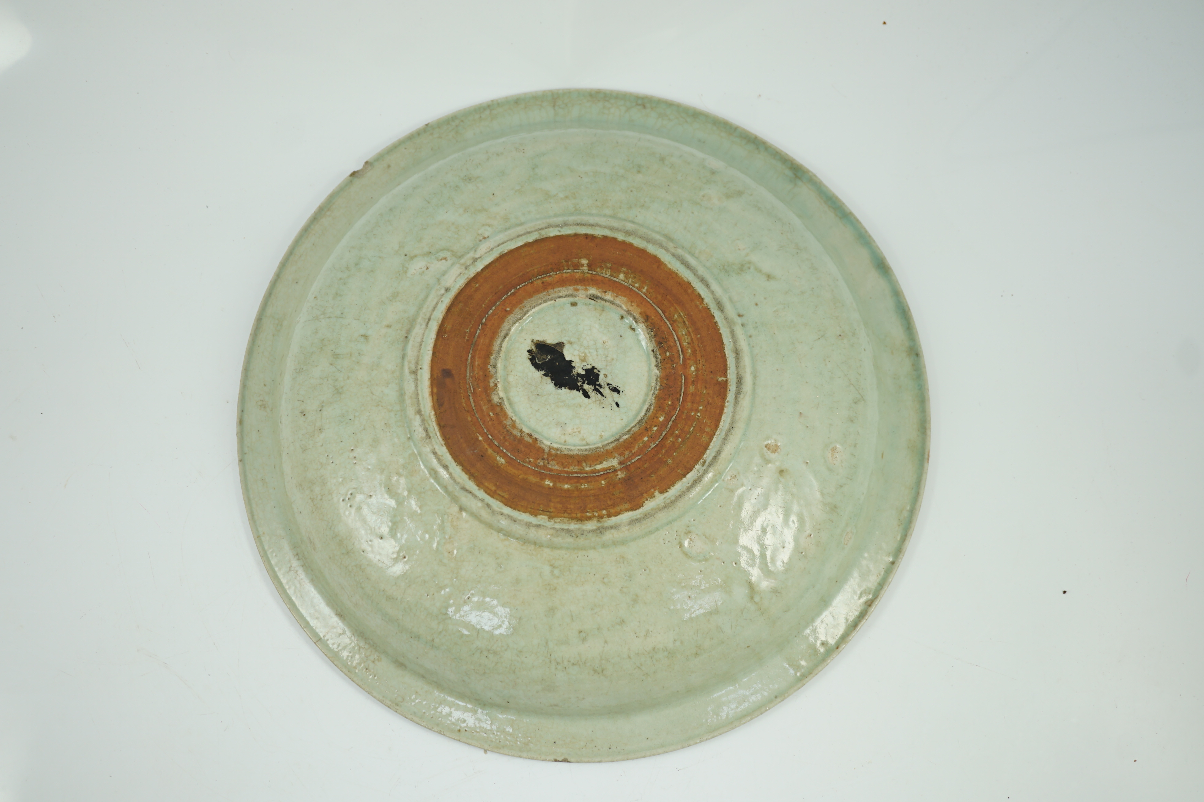 A Chinese Longquan celadon dish, Yuan-Ming dynasty, 13th/14th century, some faults